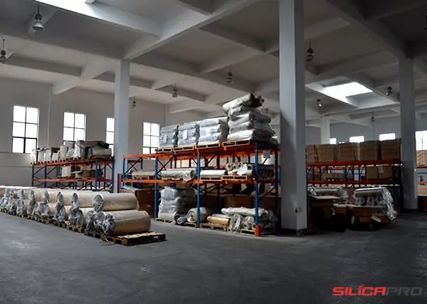 Warehouse racking holding high silica fabric rolls and packed goods