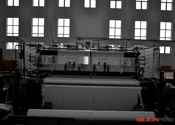 Wide industrial loom weaving a roll of high silica fabric