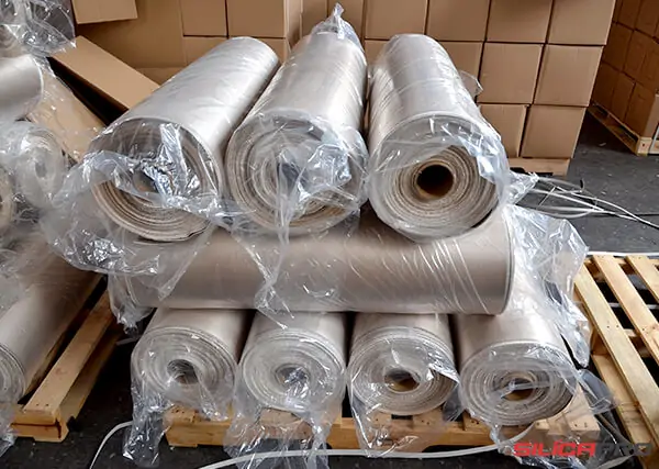 Coated silica fabric rolls wrapped in protective plastic on pallets
